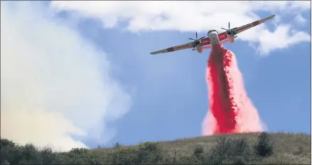  ?? KENT PORTER — THE PRESS DEMOCRAT VIA AP ?? Cal Fire air tankers help stop the spread of a brush fire in Larkfield, Calif., Thursday,