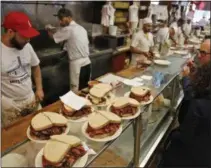 ?? PHOTS BY SETH WENIG — ASSOCIATED PRESS ?? Orders are ready to go out at Katz’s Delicatess­en in New York Thursday. The famed New York City restaurant that made a name for itself during World War II with the slogan “send a salami to your boy in the Army,” is launching an expanded global delivery...