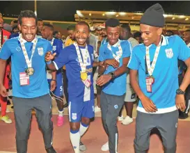  ??  ?? Al Nasr players break into a jig to celebrate their team’s fifth HM’s Cup title at the SQSC on Thursday