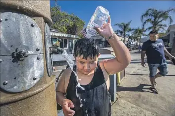  ?? Photograph­s by Francine Orr Los Angeles Times ?? RAYMOND VALDEZ, 8, rinses with seawater on the beach in Avalon, where conservati­on is a way of life.