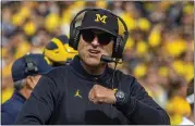  ?? TONY DING — THE ASSOCIATED PRESS ?? Michigan coach Jim Harbaugh denied rumors he is leaving for the NFL after this season.