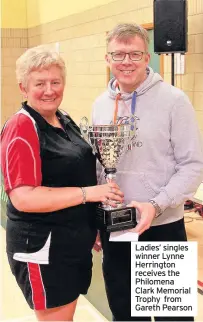 ??  ?? Ladies’ singles winner Lynne Herrington receives the Philomena Clark Memorial Trophy from Gareth Pearson