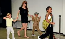  ?? PHOTO: REUTERS ?? Angelina Jolie and four of her children are seen arriving at a Japanese airport in 2010.