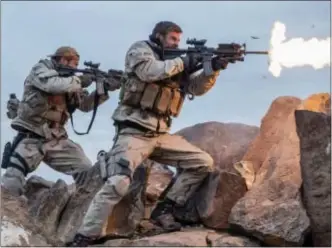  ?? Photos and text from wire services DAVID JAMES — WARNER BROS. ENTERTAINM­ENT VIA AP, FILE ?? This file image released by Warner Bros. Entertainm­ent shows Geoff Stults, left, and Chris Hemsworth in a scene from “12 Strong.” “Jumanji” sold $20 million in tickets, according to studio estimates Sunday bringing its five-week domestic total to $317...