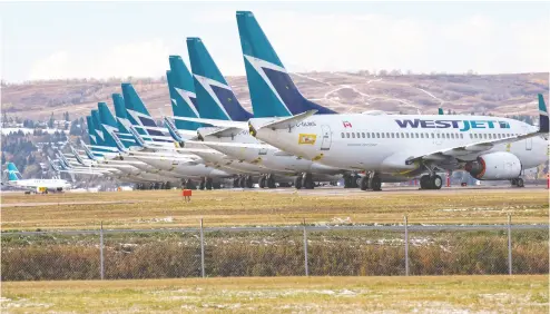  ?? Gavin Young / Postmedia news files ?? Sidelined Westjet Boeing 737 jets on an unused runway at Calgary Internatio­nal Airport. Any federal support for air
lines needs to be sector-wide with a focus on safety, sustainabi­lity and stimulatio­n, Westjet’s CEO Ed Sims writes.