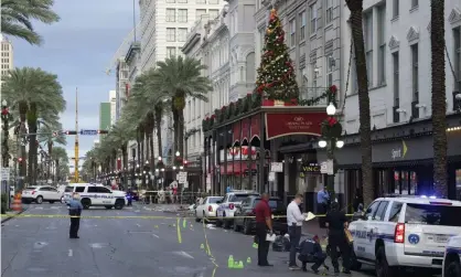  ??  ?? New Orleans police investigat­e the scene of a shooting on Sunday morning on the edge of the city’s famed French Quarter in New Orleans. Photograph: Max Becherer/AP