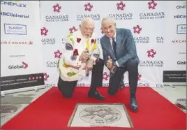  ?? CP PHOTO ?? Don Cherry and Ron MacLean pose for a photo during the unveiling of their joint star on Canada’s Walk of Fame in Toronto.