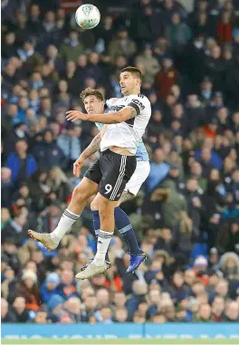  ?? AFP ?? Manchester City’s English defender John Stones (left) vies with Fulham’s Serbian striker Aleksandar Mitrovic during their English League Cup fourth round match at the Etihad Stadium in Manchester on Thursday. Manchester City won 2-0. —