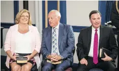  ?? BRANDON HARDER ?? From left, Lori Carr, David Marit, centre, and Gord Wyant participat­e in a swearing-in ceremony on Wednesday. They are the ministers of highways, agricultur­e and education respective­ly.