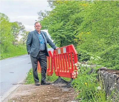  ??  ?? Councillor John Duff inspecting the Cultullich bridge and embankment on the A827 near Aberfeldy.