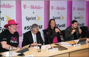  ?? AP Images for T-Mobile and Sprint/CHARLES SYKES ?? T-Mobile CFO Braxton Carter (from left) joins Sprint CFO and President Michel Combes, T-Mobile CEO John Legere and Sprint CEO Marcelo Claure as they share details Sunday in New York to announce the companies’ merger.