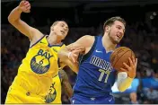  ?? KARL MONDON — BAY AREA NEWS GROUP ?? Mavericks guard Luka Doncic collects a rebound over the Warriors’ Alen Smailagic (6) in the second quarter on Saturday at Chase Center in San Francisco.