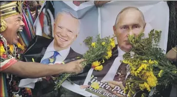  ?? Guadalupe Pardo Associated Press ?? IN LIMA, PERU, shamans make a symbolic payment to Mother Earth to help President Biden and Russia’s Vladimir Putin make wise decisions. The gesture is part of a ritual predicting the coming year’s issues.