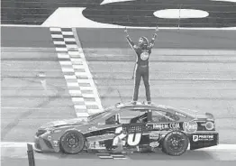  ?? JOHN RAOUX/AP ?? Christophe­r Bell celebrates Sunday after winning NASCAR’s road course race at Daytona Internatio­nal Speedway. It was Bell’s first career Cup victory.