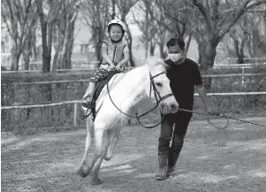  ?? Sakchai LALIT/ASSOCIATED PRESS ?? Rylae-ann Poulin, 4, rides a horse in Bangkok last month. Before receiving a promising new treatment, she couldn’t crawl or even lift her head because of a rare genetic disorder.