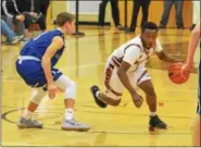  ?? THOMAS NASH — DIGITAL FIRST MEDIA FILE ?? Pottsgrove’s Manny Clark works to get around the defense of Great Valley’s Damien Carter during a game last season.