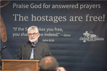  ?? PHOTOS BY COURTNEY HERGESHEIM­ER/COLUMBUS DISPATCH ?? David Troyer, general director of Christian Aid Ministries, talks during a press conference at Christian Aid Ministries, in Berlin, Ohio, on Monday. All 17 staff members of Christian Aid Ministries who were held hostage in Haiti by the 400 Mawozo gang have returned home.