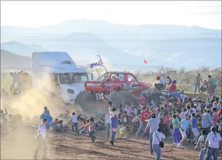  ??  ?? CARNAGE: Spectators try to flee as a monster truck ploughs towards them during a demonstrat­ion at an air show in Chihuahua, Mexico. Picture: Eduardo Alanis/Reuters