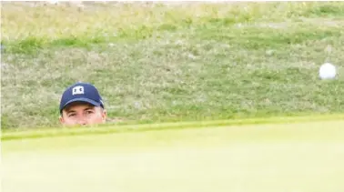  ?? AP PHOTO/MICHAEL THOMAS ?? Jordan Spieth watches his golf ball after hitting from a bunker on the 12th hole during the final round of the Valero Texas Open on Sunday in San Antonio.