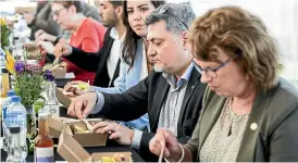  ?? DAVID UNWIN/ STUFF ?? Israeli ambassador to New Zealand, Ran Yaakoby, getting a taste of what Feilding’s Farmers’ Market has to offer.