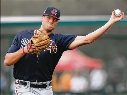  ?? CURTIS COMPTON / CCOMPTON@AJC.COM ?? Braves relief pitcher Adam McCreery throws to third while practicing his fielding on Feb 17, in Lake Buena Vista. McCreery has impressed the team’s coaches after solid outings in low- and high-A baseball.