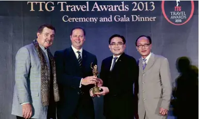  ??  ?? RECEIVING the award at the TTG Travel Awards 2013 gala dinner: Fairmont Makati managing director Tom Meyer and director of sales andmarketi­ng Eugene Tamesis (second and third from left)