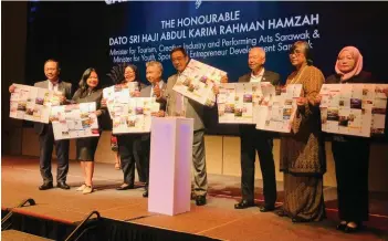  ?? ?? Abdul Karim (fourth right), Ting (third right), Snowdan (fourth left) and others pose with the Calendar of Events for 2024 brochure.