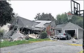  ?? Carl Russo Eagle-Tribune ?? A SERIES OF GAS explosions and fires last week killed a young man and hurt dozens in the Boston area. Leonel Rondon, 18, died when a chimney struck his car.