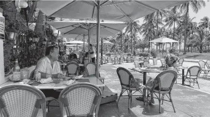  ?? ZACHARY FAGENSON • REUTERS ?? Customers sit at Il Giardino restaurant on Ocean Drive on South Beach in Miami.