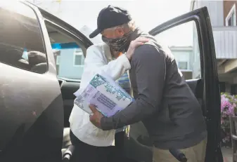  ??  ?? David Mann hugs mother Marjorie as he drops her off at the facility after an outing to Kohl's. “Oh, I don’t know what I would’ve done without him this past year,” Marjorie said of David.