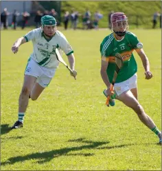  ??  ?? Kilcoole’s Luke Evans comes under pressure from Arklow Rocks fullback Martin Gilbert during the IHC clash in Rathnew.