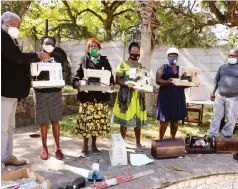  ?? UMRRT), ?? Director of the United Mutare Residents and Ratepayers’ Trust ( Bishop Dr Sebastain Bakare (left) donates sewing machines to less privileged women groups, while the trust’s coordinato­r, Mr Edison Dube, (far right) looks on. Picture by Tinai Nyadzayo.