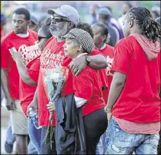  ??  ?? Mumford family members console each other at the Ibrahim Sankoh, Jerrett Mumford and Jaylen Mumford memorial service at Banneker High School on Thursday.