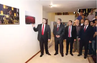  ??  ?? Turkey’s Ambassador to Kuwait Salih Murat Tamer tours guests in a gallery showing pictures of Turkish people supporting President Recep Tayyip Erdogan. — Photos by Yasser Al-Zayyat