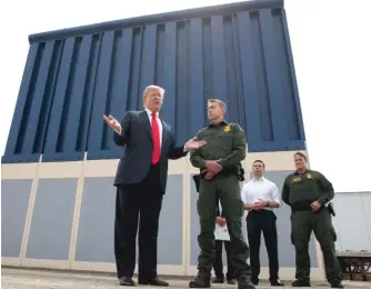  ?? EVAN VUCCI/AP FILE ?? President Donald Trump talks with reporters as he reviews border wall prototypes in San Diego on March 13, 2018. Illinois joined California and 14 other states in filing a lawsuit Monday against Trump's emergency declaratio­n to fund a wall on the U.S.-Mexico border.