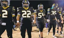  ?? Lara Solt For The Times ?? JONESBORO PLAYERS head out for the coin toss before a six-man football game in Hico, Texas. Many rural schools in the state can’t field 11-man teams.