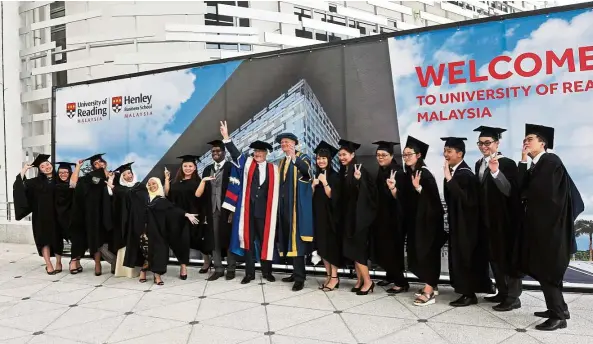  ??  ?? University of Reading Malaysia (UoRM) graduates posing with University of Reading vice-chancellor Sir David Bell (in blue and yellow) and UoRM provost Tony Downes (in red, white and blue) at the UoRM campus in EduCity, Iskandar Puteri. UoRM is one of...