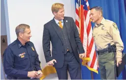  ??  ?? From left, Albuquerqu­e Police Chief Mike Geier, Albuquerqu­e Mayor Tim Keller and Bernalillo County Sheriff Manuel Gonzales chat together after a news conference Tuesday announcing an interagenc­y coordinati­on to deal with auto thefts in Bernalillo County.