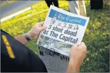  ?? Patrick Semansky Associated Press ?? FRIDAY’S front page of the Capital featured photos of the five victims. The opinion page was left mostly blank in memoriam.