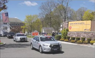  ?? H John Voorhees III / Hearst Connecticu­t Media fille photo ?? First responders parade past the entrance to New Milford Hospital to thank staff for their work on the front lines fighting the coronaviru­s on April 28. A $15,000 sustainabi­lity fund was created earlier this year to help first reponders, residents and small businesses with finances in the event state, federal and local funds fell short.