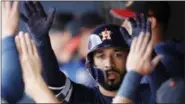  ?? JOHN BAZEMORE - THE ASSOCIATED PRESS ?? Houston Astros left fielder Marwin Gonzalez (9) celebrates in the dugout after hitting a home run iagainst the Washington Nationals, Tuesday in West Palm Beach, Fla.