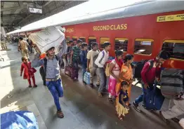  ?? — PTI ?? Migrant workers board a train in Ahmedabad on Tuesday in view of protests and violence breaking out over the alleged rape of a 14- month- old girl in Sabarkanth­a district.