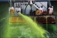  ?? ABEL URIBE — CHICAGO TRIBUNE VIA AP ?? Crews on boats begin dumping green dye into The Chicago River on March 13 in Chicago.