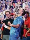  ?? Clive Brunskill/Getty Images ?? Novak Djokovic celebrates in his team's box after winning the Men's Singles Final match against Stefanos Tsitsipas at the Australian Open Sunday in Melbourne, Australia.