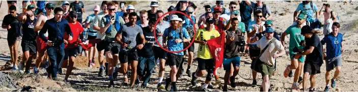  ?? ?? Finishing line: Russ Cook, circled, is joined by supporters as he approaches the end of his journey at the most northerly point of Africa in Tunisia yesterday