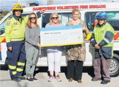  ??  ?? Fire brigade volunteers present the cheque to Ronald McDonald House. From left, fireman Craig Brown, Kay Steed, Sandie King, Penny McEwan of Ronald McDonald House and Neville Jacobsen.