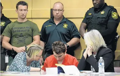  ?? TAIMY ALVAREZ/STAFF PHOTOGRAPH­ER ?? Nikolas Cruz appears in courtWedne­sday with his defense attorneys Melisa McNeill, left, and Diane Cuddihy in front of Broward Circuit Judge Elizabeth Scherer for a hearing that may decide who will represent him in a bid to spare his life.