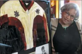  ?? ANDREW WELSH-HUGGINS — THE ASSOCIATED PRESS ?? Ramona Isbell talks about her days as a profession­al wrestler in the 1960s and 1970s beside a framed collage of mementos including publicity photos and a jacket, on Monday in Columbus, Ohio.