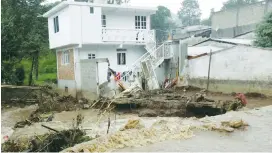  ?? (Reuters) ?? A HOUSE DAMAGED after a river overflowed its banks following heavy showers caused by the passing of Tropical Storm Earl in the town of Huauchinan­go in Puebla state on Sunday.