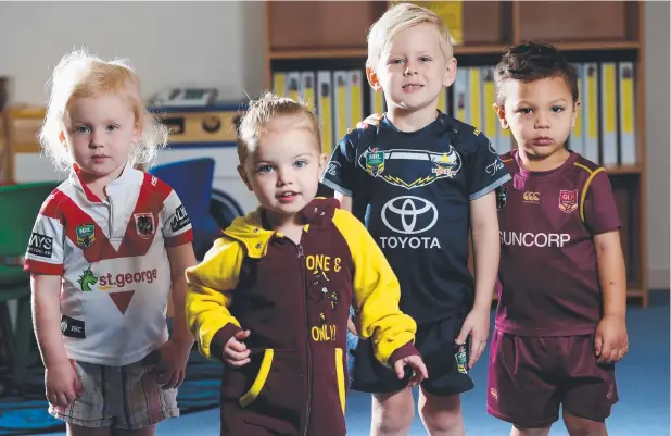 ?? Picture: STEWART McLEAN ?? DRESSED UP: Charlotte Kopke, 2, Kadeisha Addo, 3, Seth Kopke, 4, and Denzel Lyons, 2, in footy colours at Cairns Kids Early Learning Centre.